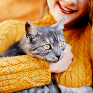 Woman holding a cat to show gift for cat lovers