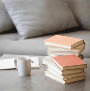 Image of books in a living room to make your home more enjoyable when finding balance. 