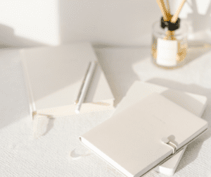 Journals and notebooks on desks showing reducing to digital for paper declutter where possible.