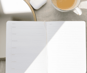 Image of planner open on desk to show how you can utilize one space as opposed to many papers around you office space.