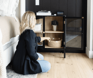 Image of woman putting away items in a storage basket.