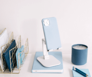 Image of a phone sitting in a stand ready for recording instagram reels to use as Pinterest Idea Pins.