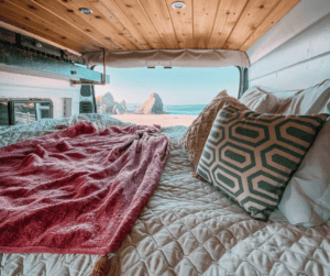 An image of a bed in a van showing renting a van fun things for a couple to do.