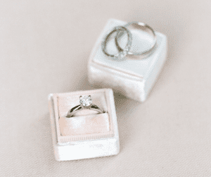 Image of wedding bands in a plush jewlery box showing summer cleaning your rings. 