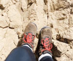 An image of hiking boots on rocks showing you can go on a hiking date as a couple!