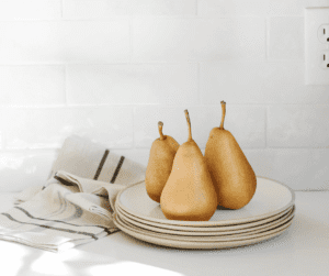 Images of 3 pears sitting on white plates as a good fibre snacks ideas. 