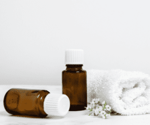 Two brown essential oils bottle showing the benefits for Frankincense and Geranium for Essential oils for anxiety. 