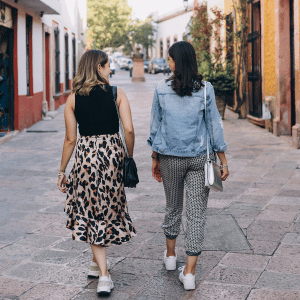Image of two women walking around in summer.